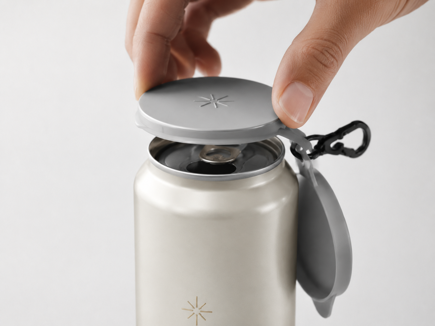 A hand placing a TwinCaps cover onto an open beverage can